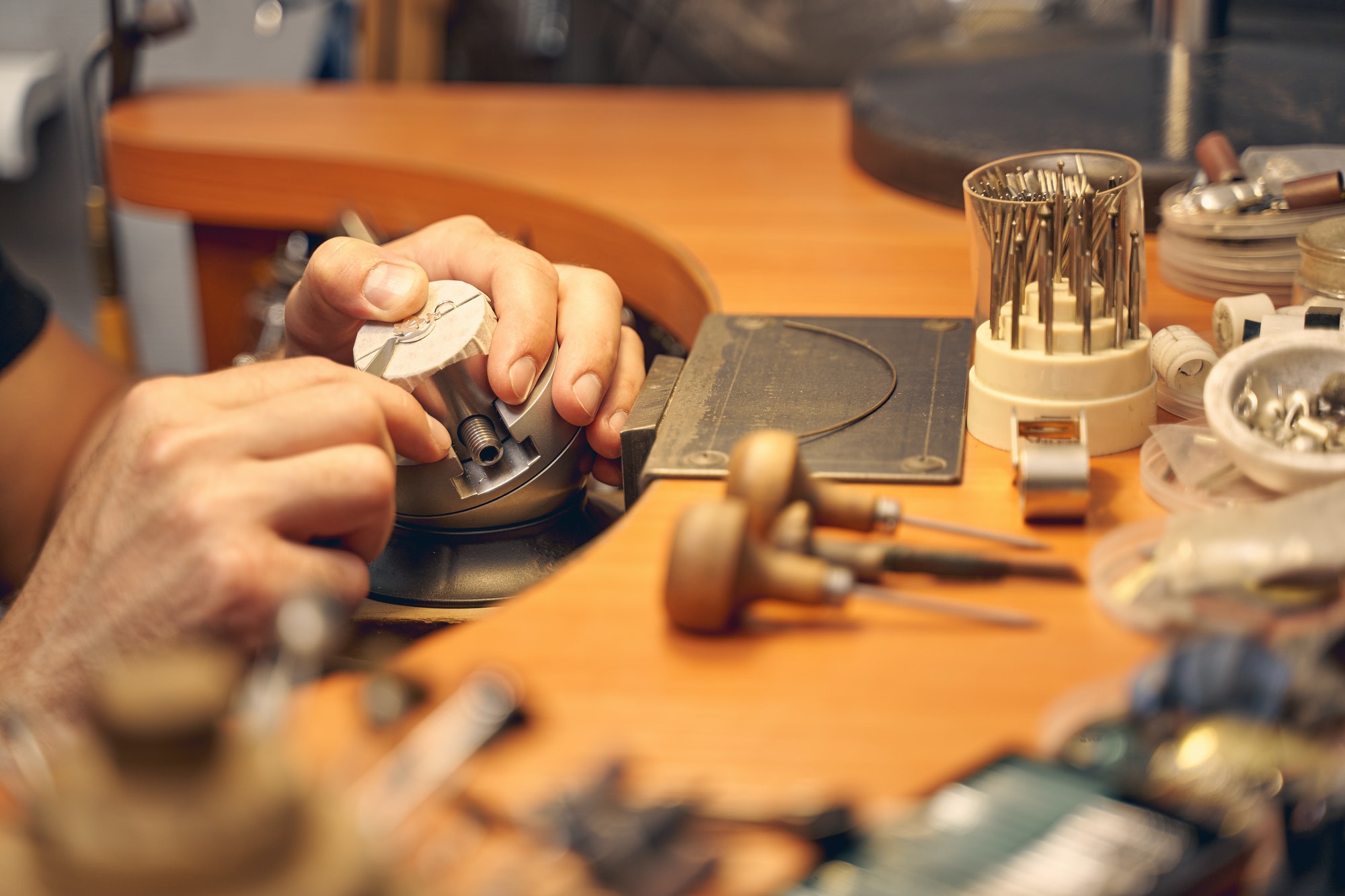 Male jeweler working with an engraving tool